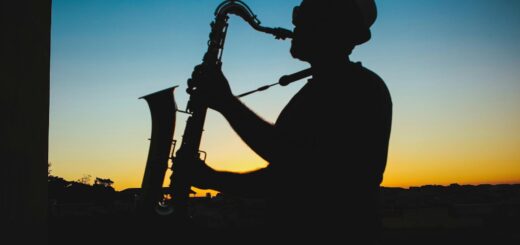 silhouette of a man playing saxophone during sunset